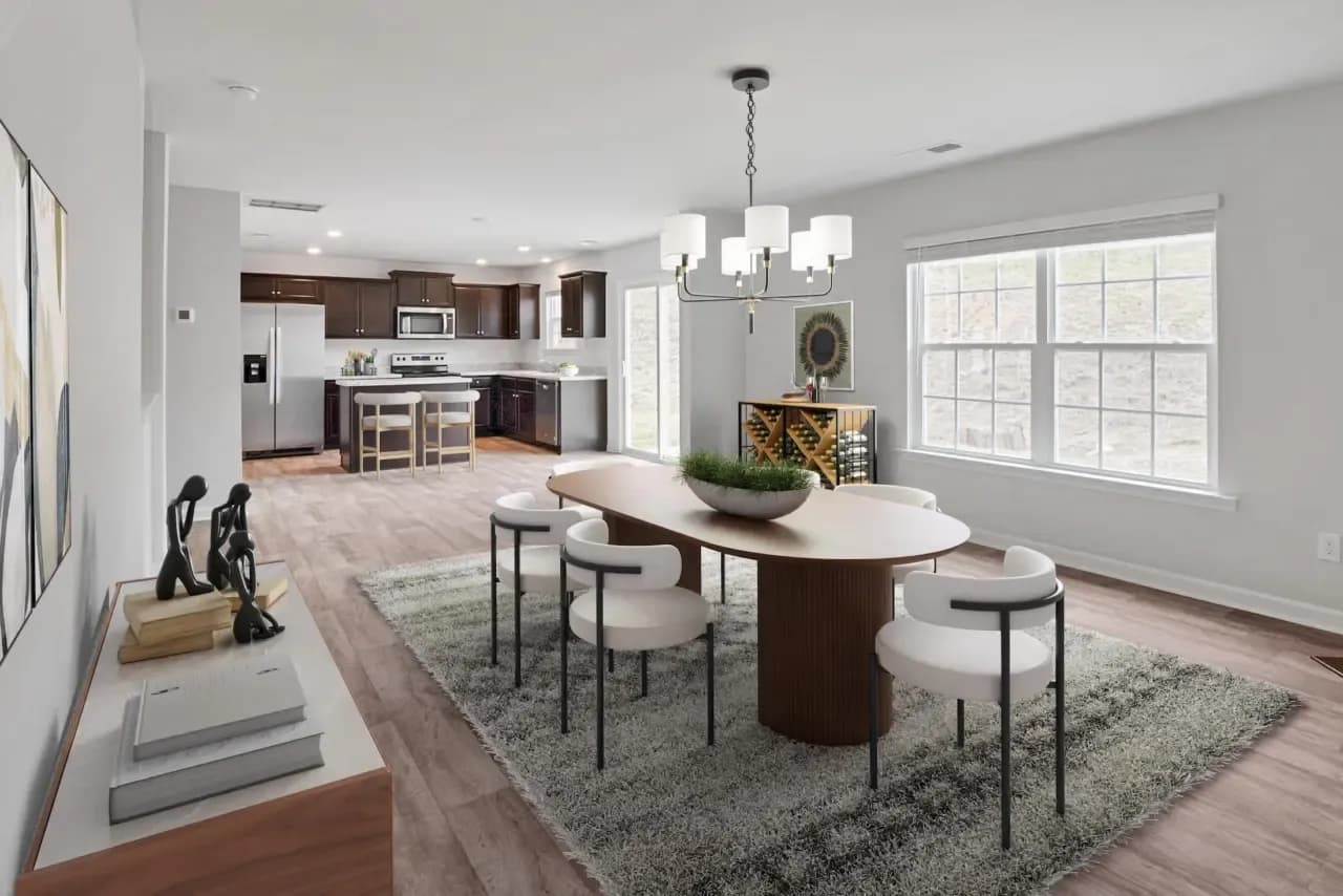 Same room virtually staged with a dining table, chairs, rug and sideboard