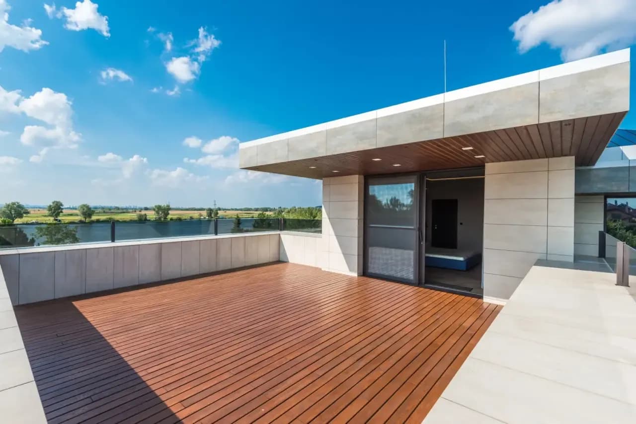 Empty wood-decked terrace with glass railing before virtual staging