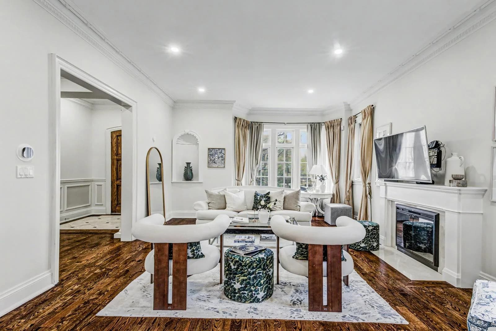Wide living room view with two stools, glass table and fireplace at 200 Glenayr Road